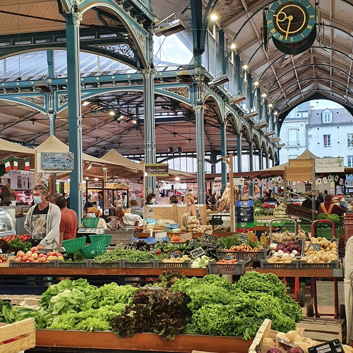 The magnificent covered Halles de Dijon market, designed by Gustave Eiffel, overflowing with the finest seasonal produce of Burgundy