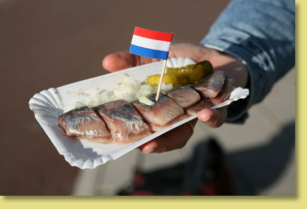 Traditional Dutch food in Amsterdam: a spread of typical dishes including herring, stroopwafels and aged cheese