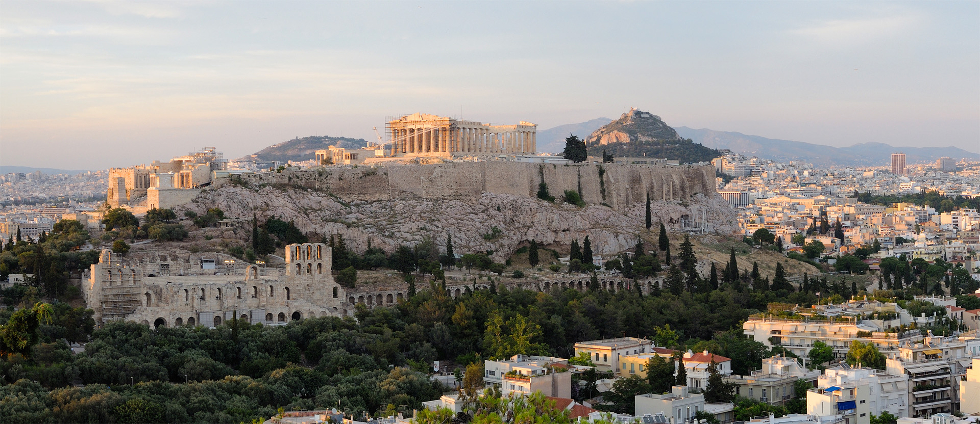 The Acropolis of Athens rising above the city: the Parthenon and the surrounding monuments of ancient Greek civilisation at golden hour
