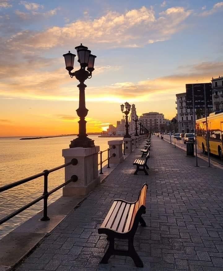 The seafront promenade of Bari at sunset, with the Adriatic Sea and the ancient watchtowers