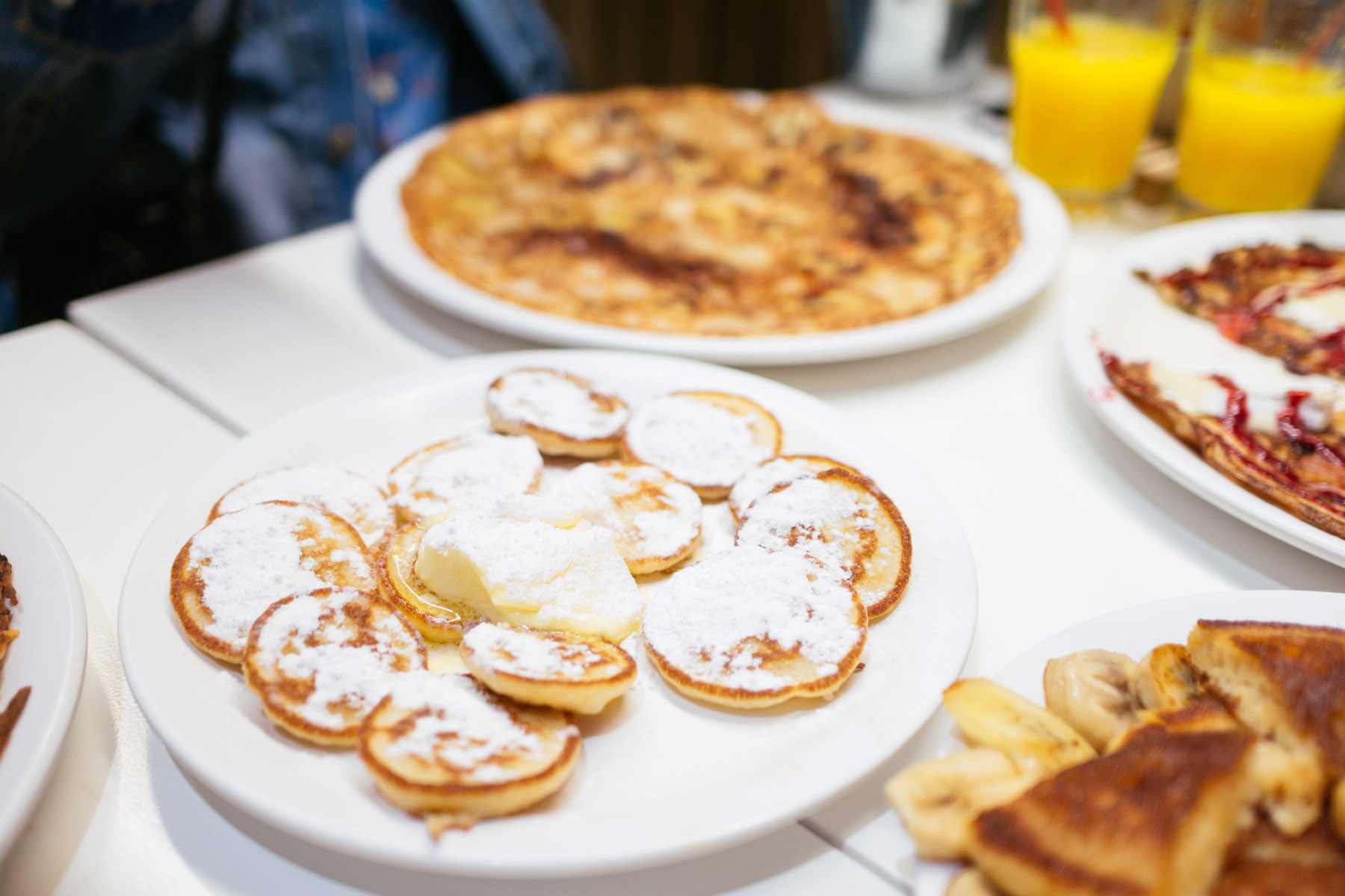 Dutch poffertjes: small fluffy pancakes served with butter and icing sugar, a beloved treat for children in Holland