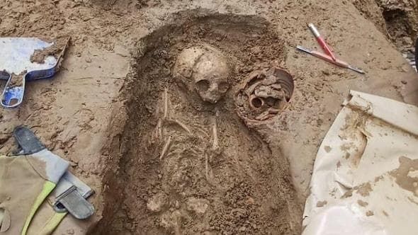 Archaeological excavation of the Roman necropolis in Florence, revealing burial structures and grave goods