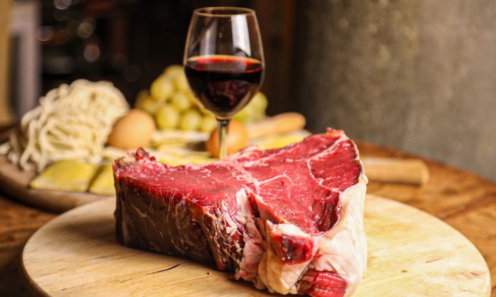A traditional bistecca alla fiorentina, a thick cut of Chianina beef grilled over charcoal, served rare and charred