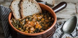 A bowl of ribollita, the traditional Tuscan bread and vegetable soup, served with a drizzle of olive oil