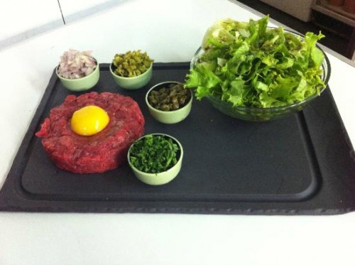 A stunning display of French pastries and patisserie in a Parisian shop window