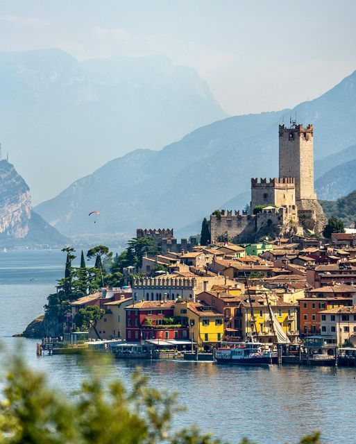 The medieval Castello Scaligero rising above the picturesque harbour of Malcesine on the eastern shore of Lake Garda, with Monte Baldo in the background