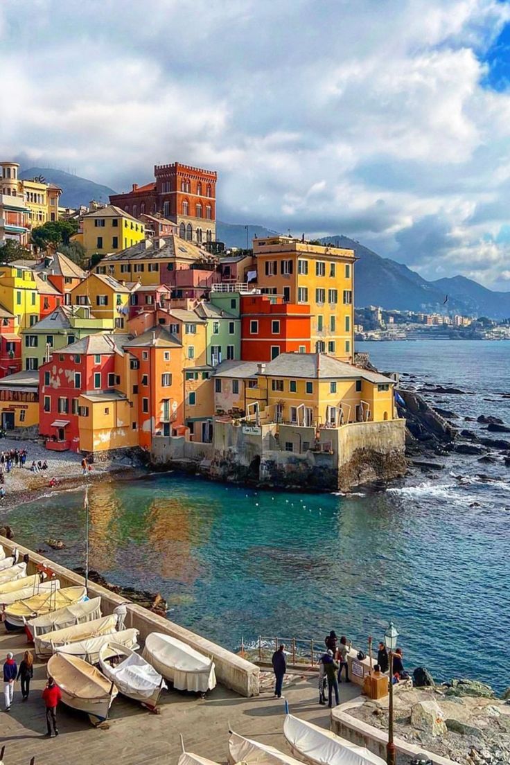 The old port of Genoa at dusk — the Lanterna lighthouse rising above the Ligurian harbour that made the city the Queen of the Sea