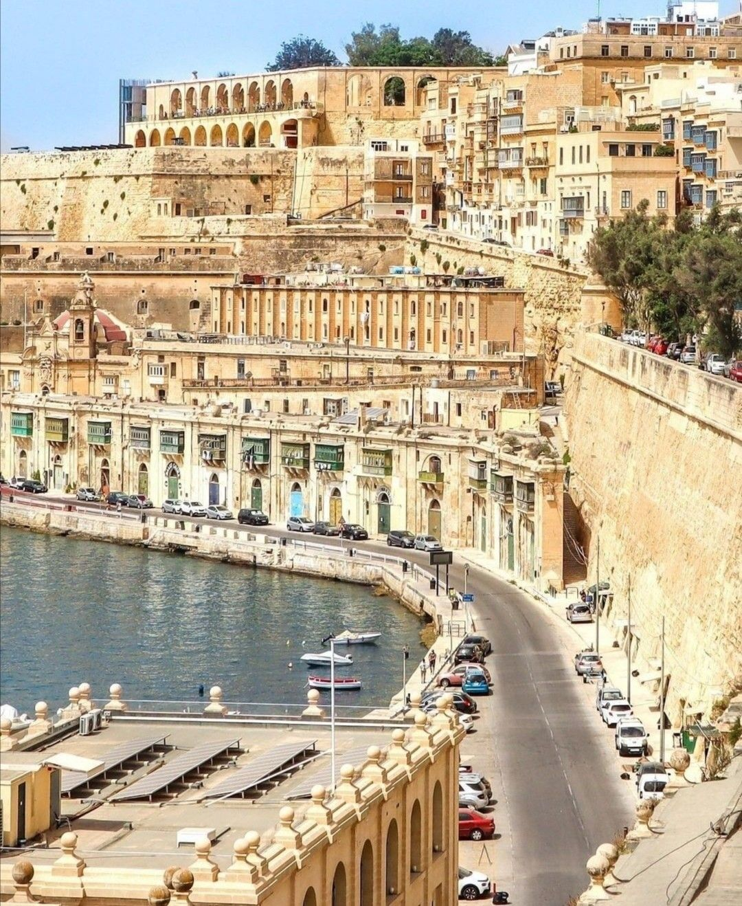 The magnificent Grand Harbour of Valletta, Malta, with the ancient limestone fortifications and the Three Cities reflected in the deep blue Mediterranean waters