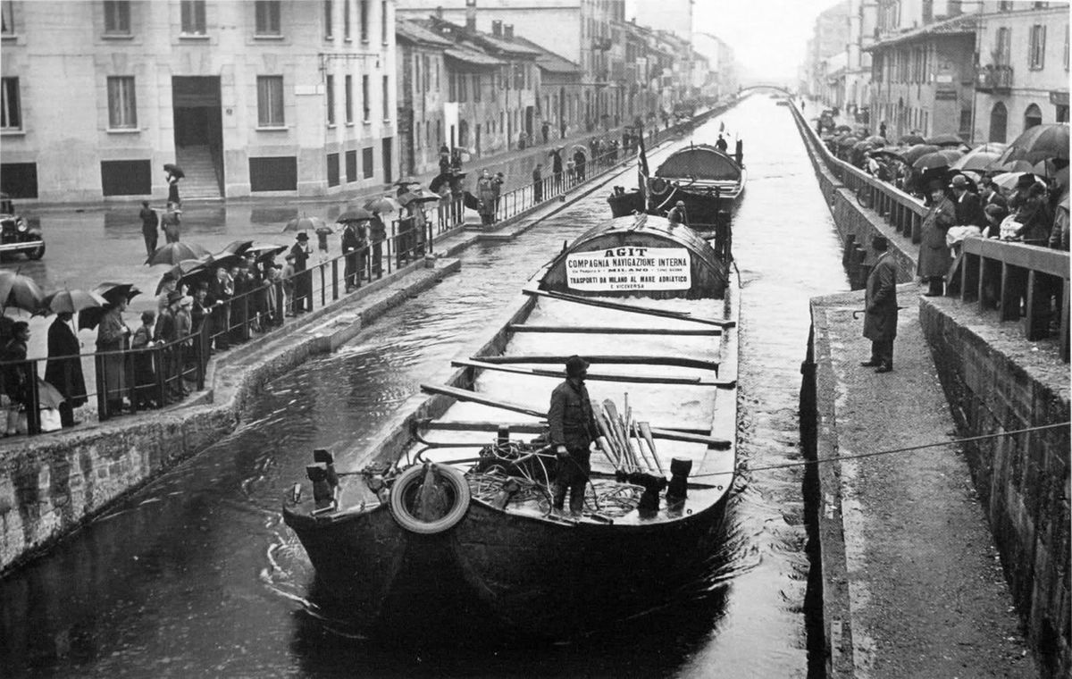 Historic photograph of the Navigli canals of Milan — boats moored along the Naviglio Grande in the early twentieth century