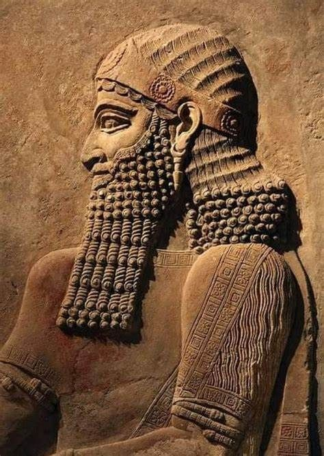 An original Assyrian alabaster relief from the palace of Nimrud, showing a winged genius pollinating the sacred tree.