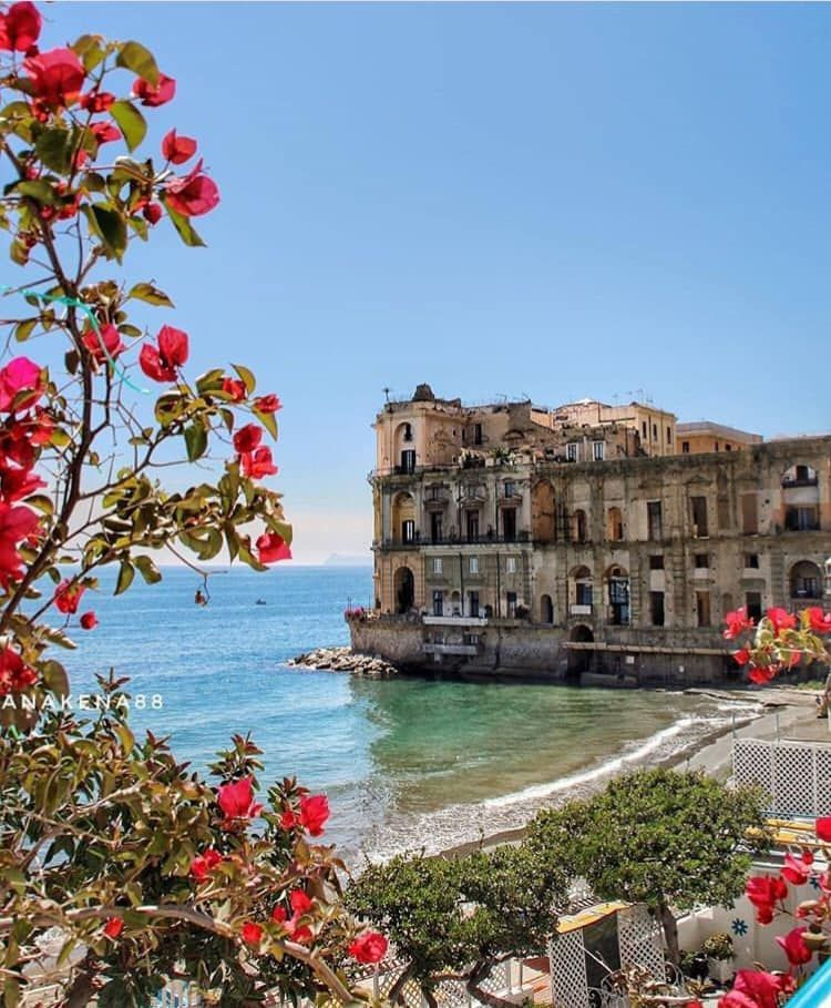 The Palazzo Donna Anna rising from the sea at Posillipo, its unfinished seventeenth-century baroque facade of yellow tuff darkened by salt air and centuries of legend