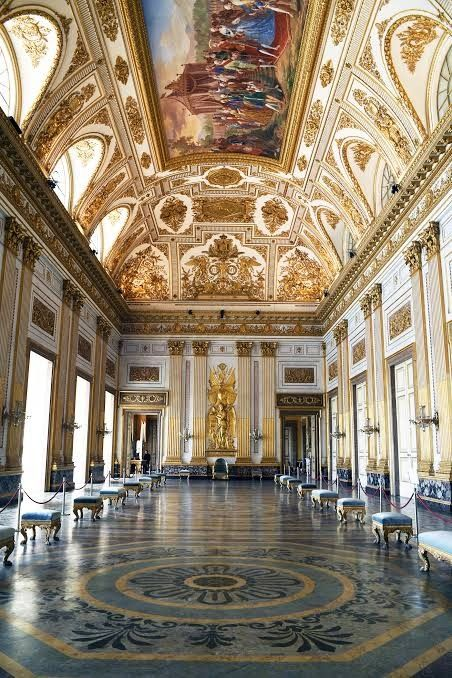 The majestic facade of the Royal Palace of Caserta, the largest royal residence in the world by volume, with its grand staircase and sweeping gardens.