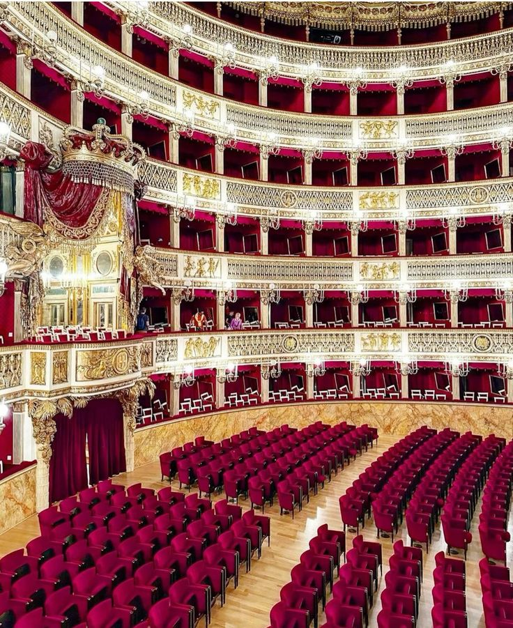 The magnificent interior of the Teatro San Carlo, with its six tiers of red and gold boxes and spectacular ceiling fresco.