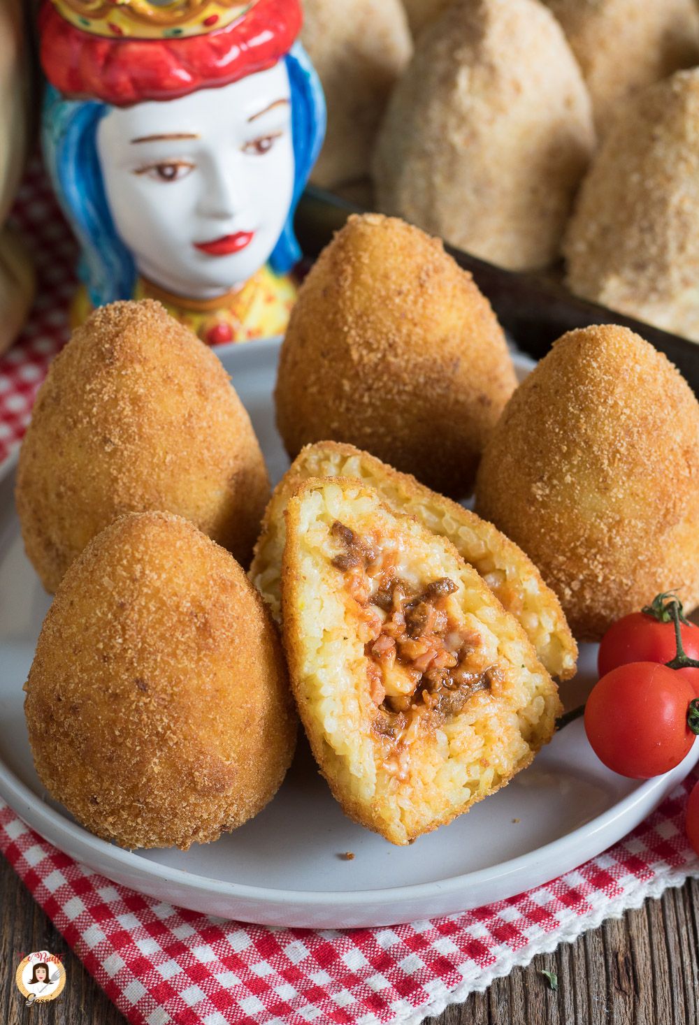 A classic Palermitan arancina filled with ragù, peas and mozzarella, served hot from a street cart