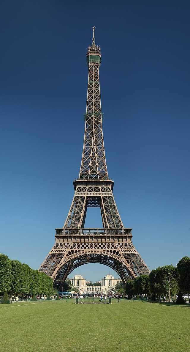 The Eiffel Tower at golden hour rising above the Seine, the defining silhouette of the City of Light