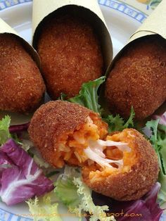 Golden fried supplì rice balls with a string of melted mozzarella, a classic Roman street food