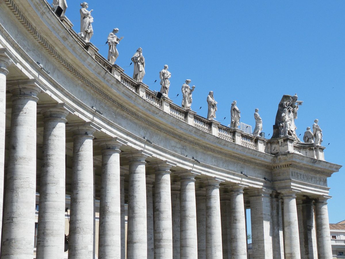 Saint Peter's Square in Rome at dawn, Bernini's colonnade embracing the empty piazza in the early morning light