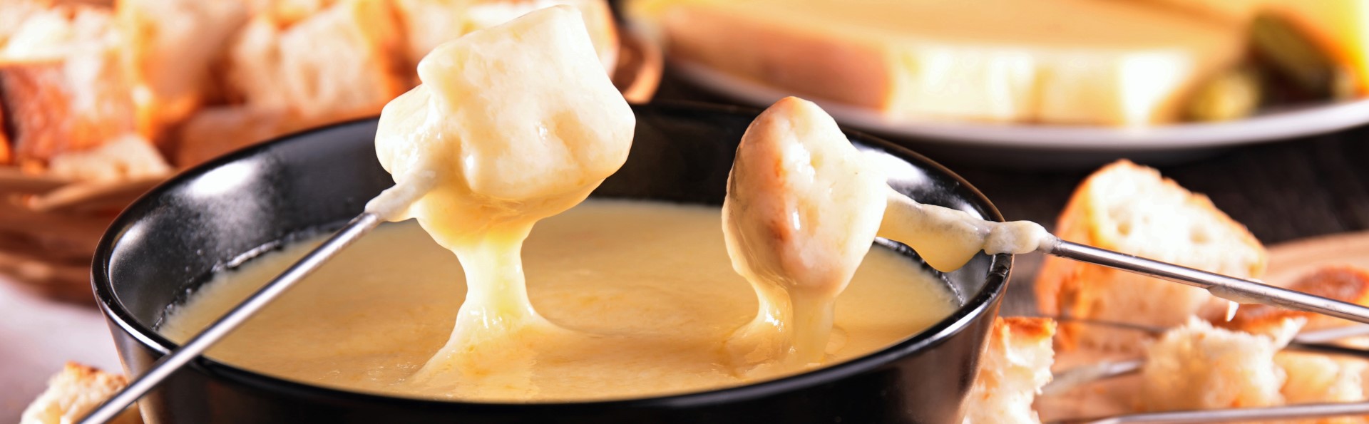 Traditional Swiss fondue with melted Gruyère and Emmentaler cheese, bread and white wine