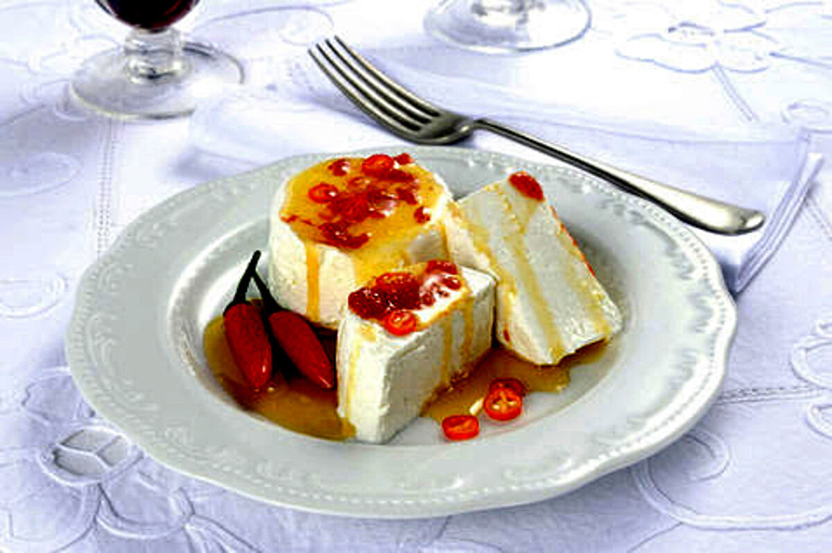 Electric tomino, a fresh Piedmontese cheese drizzled with spicy chilli oil, served as an antipasto in traditional taverns