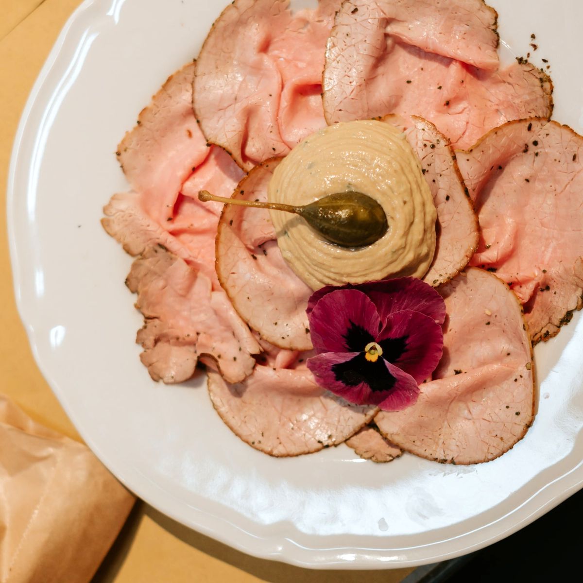 A traditional Piedmontese meal featuring bagna cauda, agnolotti del plin, a bottle of Barolo and gianduiotto chocolates