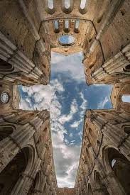 The great rose window of San Galgano Abbey's apse, framing the Tuscan sky