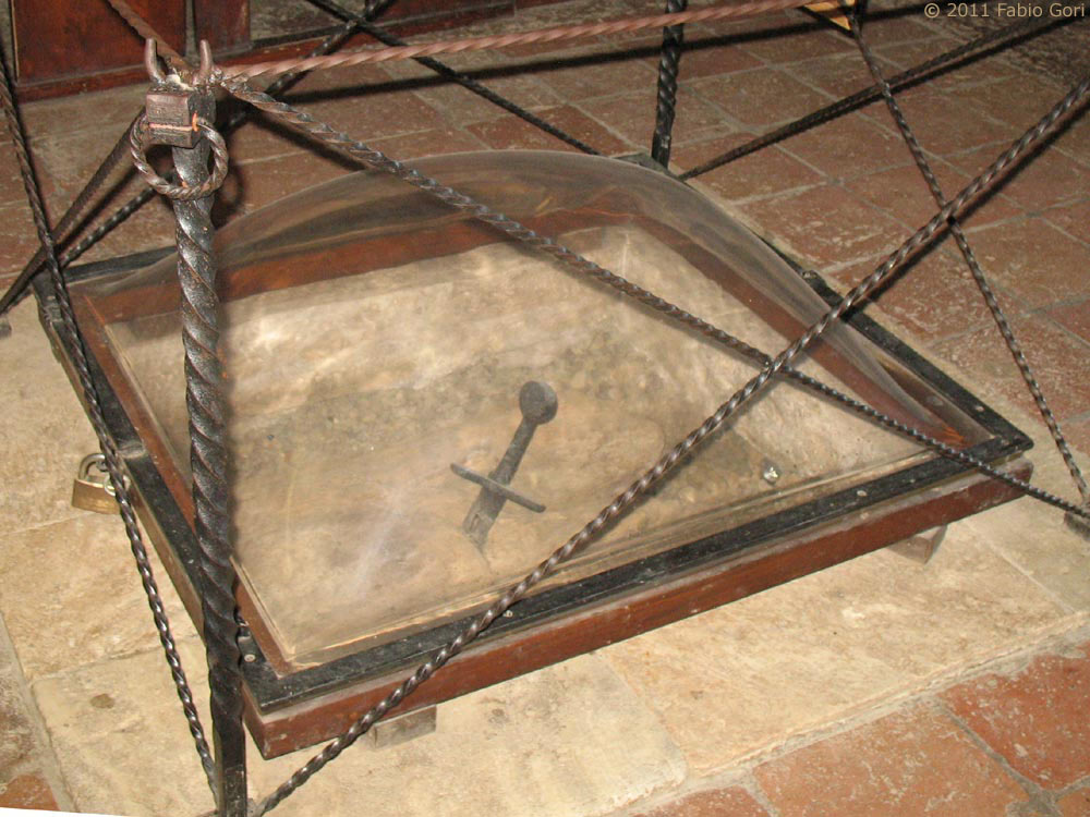 The interior of the Rotonda di Montesiepi chapel, with the sword in the stone visible beneath its conical vault