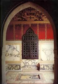 Ca' Dario bathed in golden sunset light on the Grand Canal, its marble medallions glowing warmly