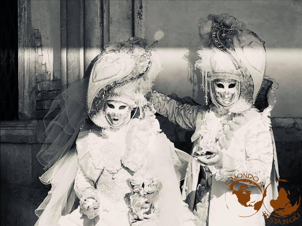 Magnificently dressed figures in historical Venetian costumes at the Venice Carnival