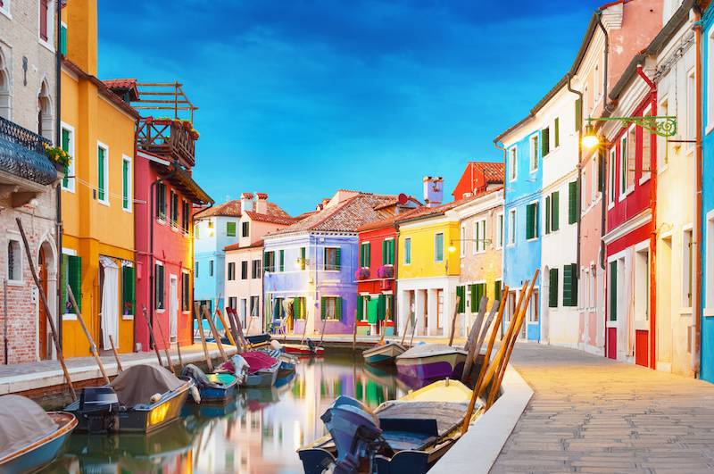 The brightly coloured houses of Burano island in the Venice lagoon, free to explore on a vaporetto pass