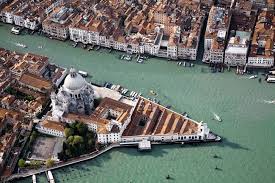 The neoclassical facade of Palazzo Grassi on the Grand Canal in Venice