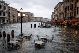 A flooded calle in Venice during acqua alta, the high water phenomenon that keeps the city's crypts permanently submerged