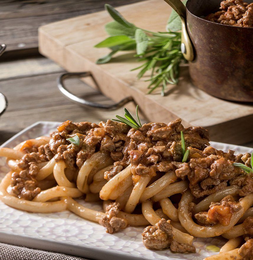 A bowl of bigoli pasta with duck ragù, a traditional Veronese first course