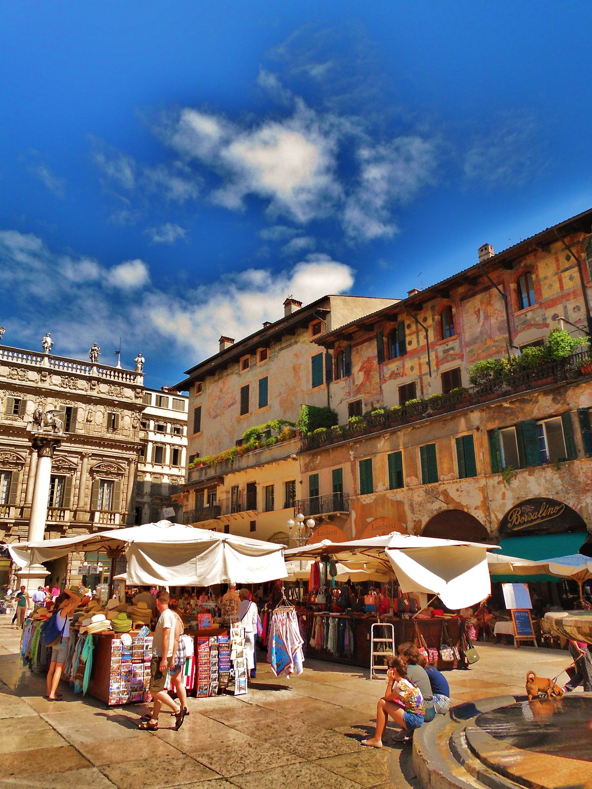 The colourful market of Piazza delle Erbe in Verona, selling local cheeses, meats and produce